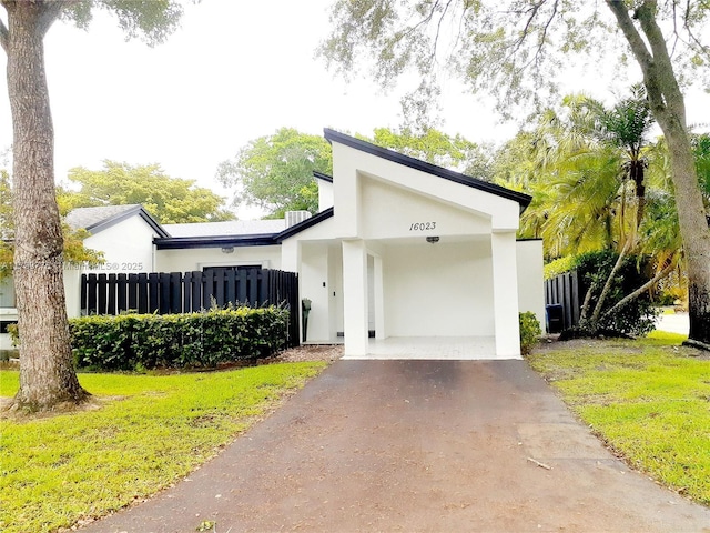 16023 S Fairway Ter Unit 118, Weston, FL 33326 - view of front of property featuring asphalt driveway, stucco siding, and a carport