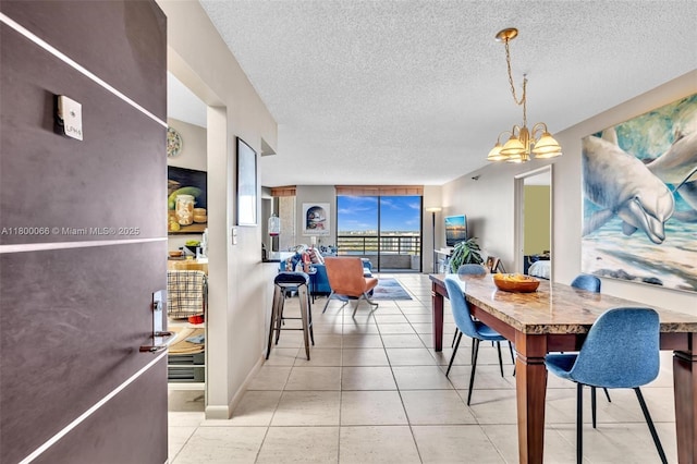 3300 NE 191st St Unit Lp04, Aventura, FL 33180 - tiled dining room with a chandelier, a textured ceiling, and baseboards