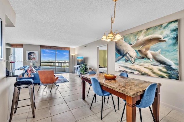 3300 NE 191st St Unit Lp04, Aventura, FL 33180 - dining space featuring a textured ceiling, a chandelier, light tile patterned floors, and baseboards