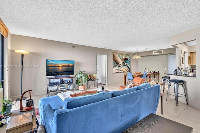 3300 NE 191st St Unit Lp04, Aventura, FL 33180 - living area with light tile patterned flooring, a textured ceiling, and a chandelier