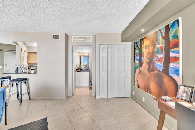 3300 NE 191st St Unit Lp04, Aventura, FL 33180 - interior space with light tile patterned floors, baseboards, and a textured ceiling