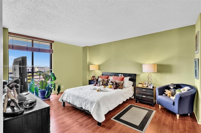 3300 NE 191st St Unit Lp04, Aventura, FL 33180 - bedroom with wood finished floors, baseboards, and a textured ceiling