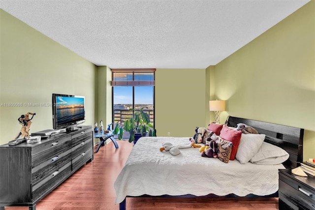 3300 NE 191st St Unit Lp04, Aventura, FL 33180 - bedroom with floor to ceiling windows, wood finished floors, and a textured ceiling