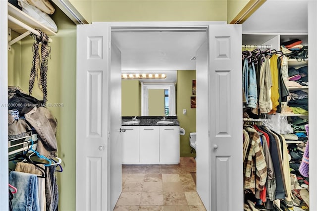 3300 NE 191st St Unit Lp04, Aventura, FL 33180 - spacious closet featuring a sink and stone finish floors