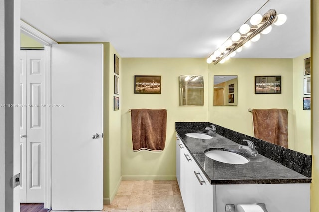 3300 NE 191st St Unit Lp04, Aventura, FL 33180 - bathroom featuring double vanity, a closet, and baseboards