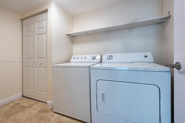1745 E Hallandale Beach Blvd Unit 1903W, Hallandale Beach, FL 33009 - clothes washing area featuring washing machine and dryer, baseboards, and light tile patterned flooring
