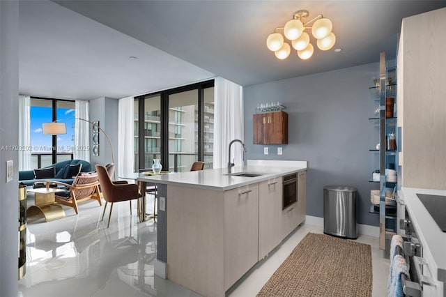 501 NE 31st St Unit 2906, Miami, FL 33137 - kitchen with a sink, modern cabinets, light countertops, a chandelier, and a peninsula