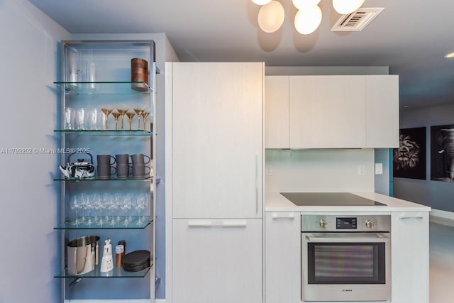 501 NE 31st St Unit 2906, Miami, FL 33137 - kitchen with oven, modern cabinets, black electric cooktop, and light countertops