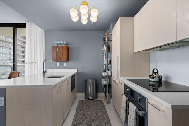 501 NE 31st St Unit 2906, Miami, FL 33137 - kitchen featuring a sink, black appliances, a peninsula, modern cabinets, and light countertops