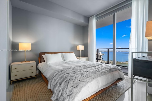 501 NE 31st St Unit 2906, Miami, FL 33137 - bedroom featuring a water view, a wall of windows, and access to exterior