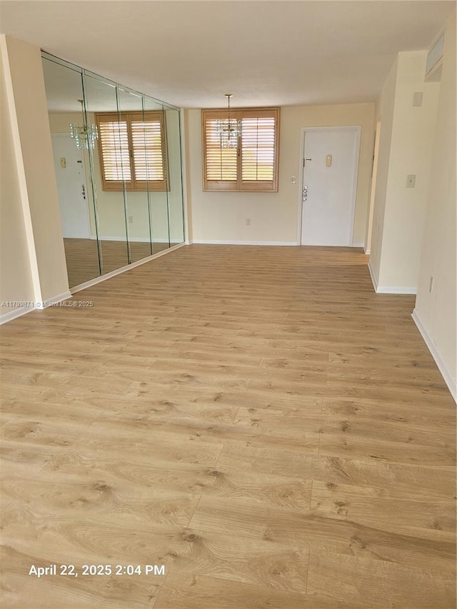 14140 SW 84th St Unit 301-H, Miami, FL 33183 - unfurnished room featuring wood finished floors, baseboards, and a chandelier