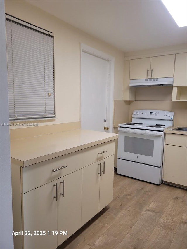14140 SW 84th St Unit 301-H, Miami, FL 33183 - kitchen with white electric range, under cabinet range hood, light wood-style flooring, and light countertops