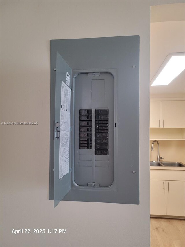14140 SW 84th St Unit 301-H, Miami, FL 33183 - utility room featuring electric panel and a sink