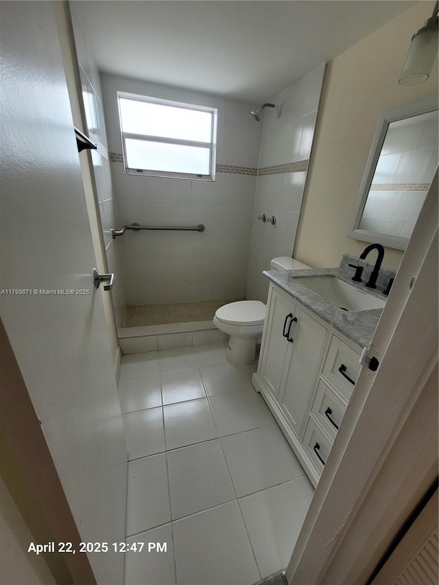 14140 SW 84th St Unit 301-H, Miami, FL 33183 - bathroom with a tile shower, vanity, toilet, and tile patterned floors