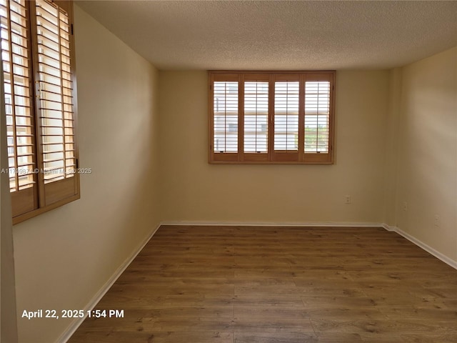 14140 SW 84th St Unit 301-H, Miami, FL 33183 - spare room featuring a textured ceiling, wood finished floors, and baseboards