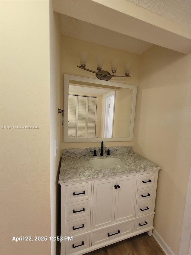 14140 SW 84th St Unit 301-H, Miami, FL 33183 - bathroom with vanity, baseboards, and wood finished floors