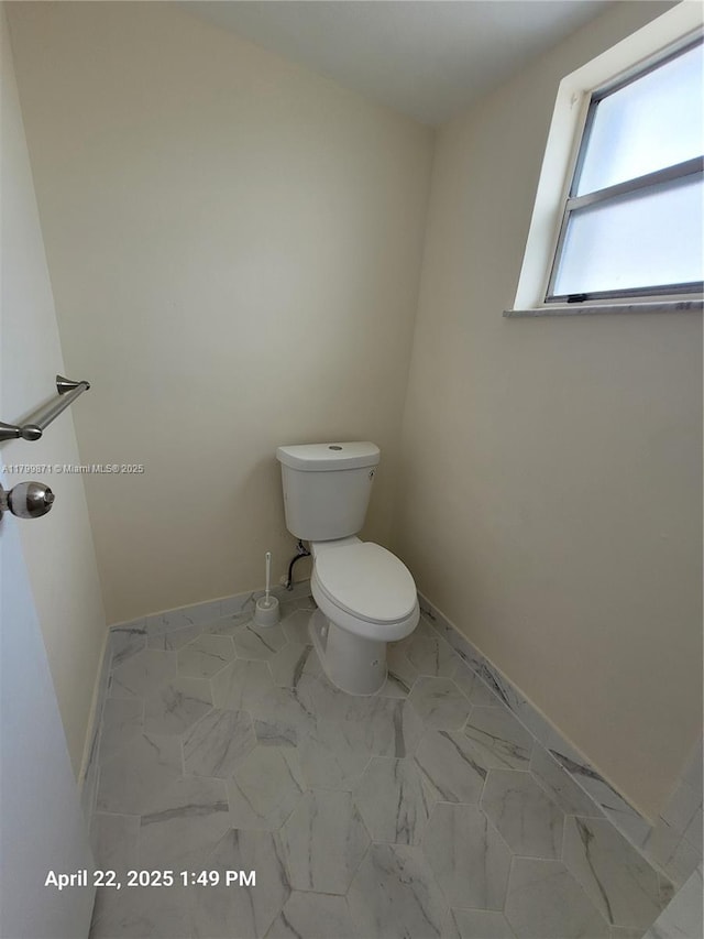 14140 SW 84th St Unit 301-H, Miami, FL 33183 - bathroom featuring toilet, baseboards, and marble finish flooring
