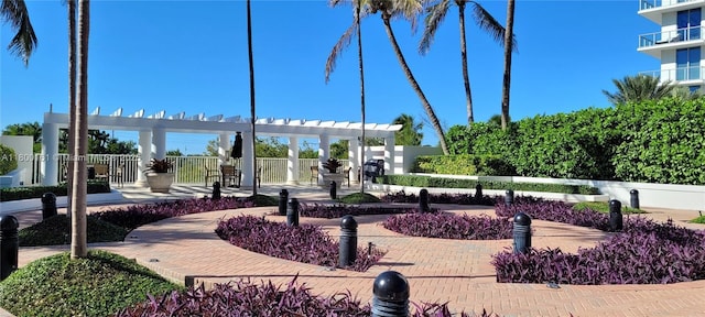 view of home's community featuring fence and a pergola