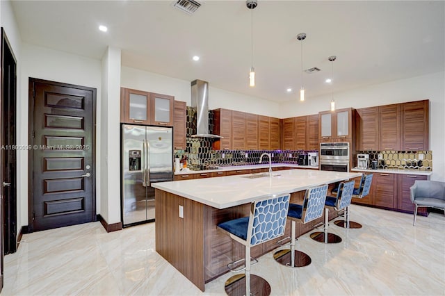 9015 NW 161st Ter, Miami Lakes, FL 33018 - kitchen featuring appliances with stainless steel finishes, wall chimney exhaust hood, decorative backsplash, a sink, and a breakfast bar