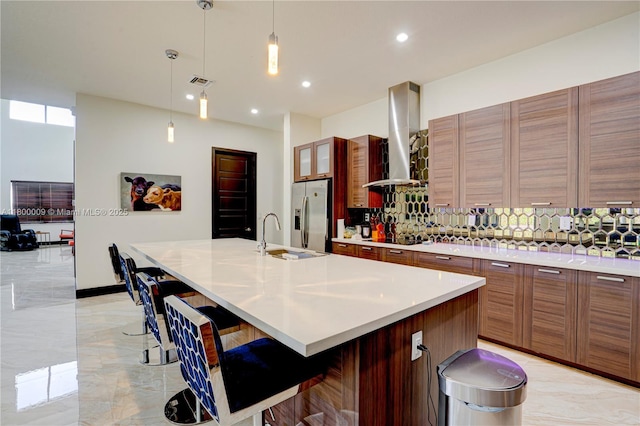 9015 NW 161st Ter, Miami Lakes, FL 33018 - kitchen featuring stainless steel fridge with ice dispenser, a sink, wall chimney exhaust hood, black electric cooktop, and light marble finish flooring