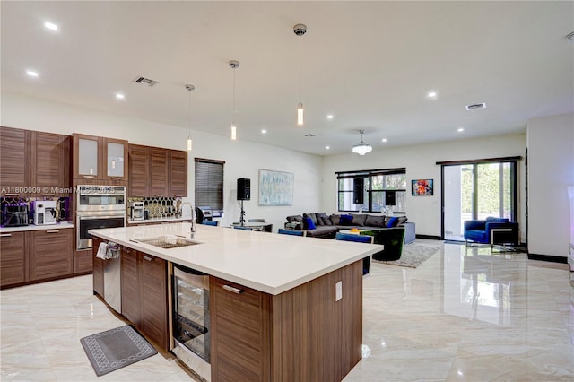 9015 NW 161st Ter, Miami Lakes, FL 33018 - kitchen with wine cooler, a sink, stainless steel appliances, light marble finish floors, and light countertops