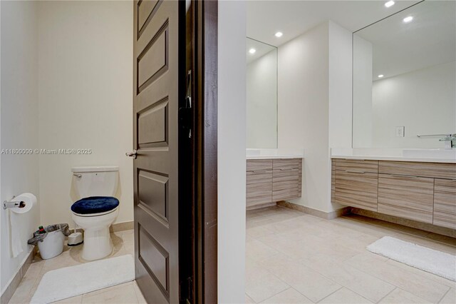 9015 NW 161st Ter, Miami Lakes, FL 33018 - bathroom with tile patterned floors, vanity, baseboards, and recessed lighting