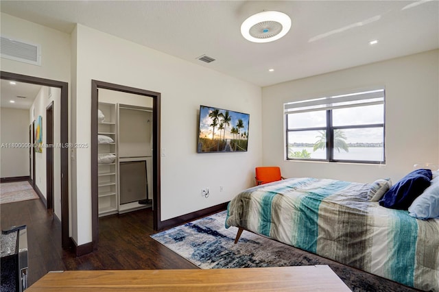 9015 NW 161st Ter, Miami Lakes, FL 33018 - bedroom featuring wood finished floors, a spacious closet, baseboards, recessed lighting, and a closet