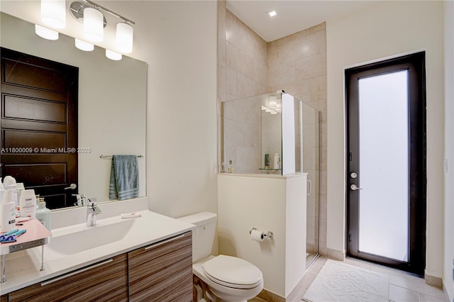 9015 NW 161st Ter, Miami Lakes, FL 33018 - bathroom featuring a tile shower, toilet, vanity, and tile patterned floors