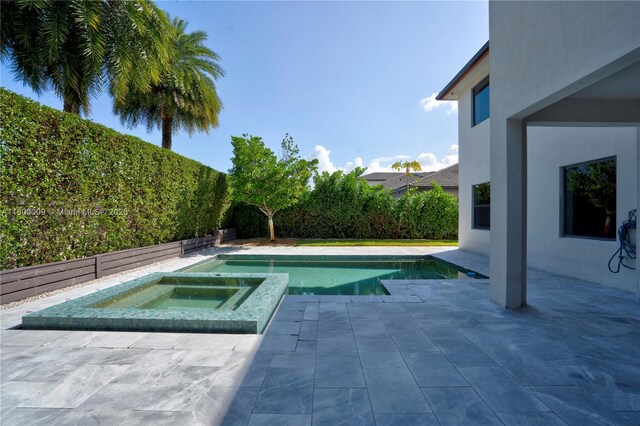 9015 NW 161st Ter, Miami Lakes, FL 33018 - view of pool with a patio, a pool with connected hot tub, and a fenced backyard