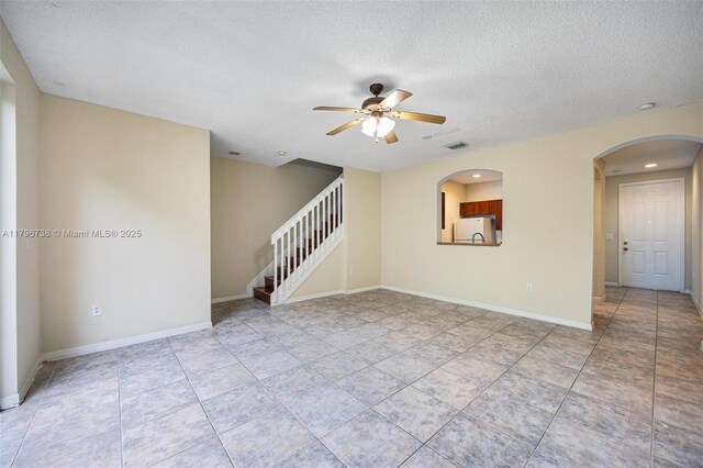 2252 NE 42nd Cir, Homestead, FL 33033 - spare room with a ceiling fan, stairs, a textured ceiling, arched walkways, and recessed lighting