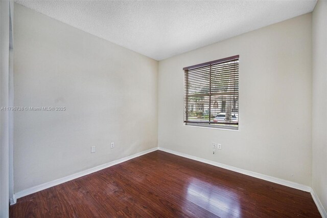 2252 NE 42nd Cir, Homestead, FL 33033 - spare room featuring wood finished floors, baseboards, and a textured ceiling