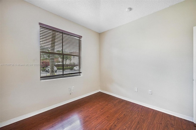 2252 NE 42nd Cir, Homestead, FL 33033 - spare room with wood finished floors, baseboards, and a textured ceiling