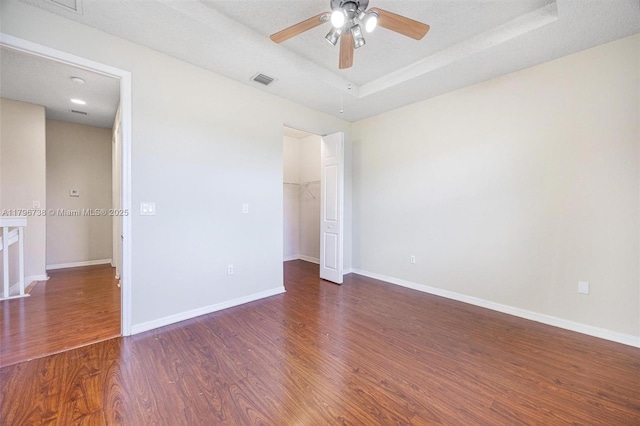 2252 NE 42nd Cir, Homestead, FL 33033 - unfurnished bedroom with wood finished floors, a tray ceiling, a closet, and baseboards