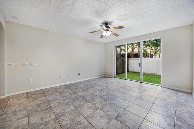 2252 NE 42nd Cir, Homestead, FL 33033 - unfurnished room featuring a ceiling fan, a textured ceiling, baseboards, tile patterned flooring, and a smoke detector