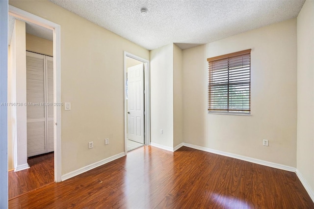 2252 NE 42nd Cir, Homestead, FL 33033 - unfurnished bedroom featuring wood finished floors, a textured ceiling, baseboards, and a closet