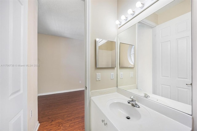 2252 NE 42nd Cir, Homestead, FL 33033 - bathroom featuring wood finished floors, a textured ceiling, vanity, and baseboards
