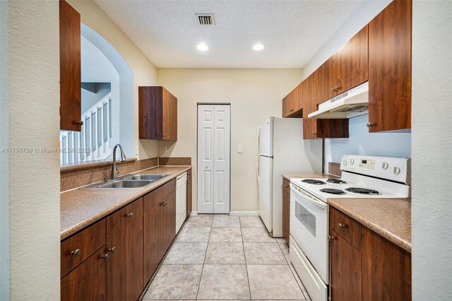 2252 NE 42nd Cir, Homestead, FL 33033 - kitchen featuring white appliances, under cabinet range hood, a sink, a textured ceiling, and recessed lighting