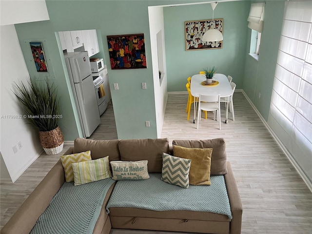 1614 Pennsylvania Ave Unit 2I, Miami Beach, FL 33139 - dining area featuring light wood-style floors and baseboards