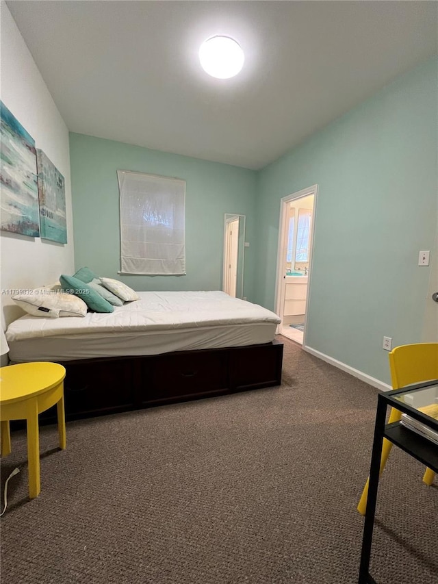 1614 Pennsylvania Ave Unit 2I, Miami Beach, FL 33139 - bedroom featuring dark colored carpet, baseboards, and ensuite bathroom