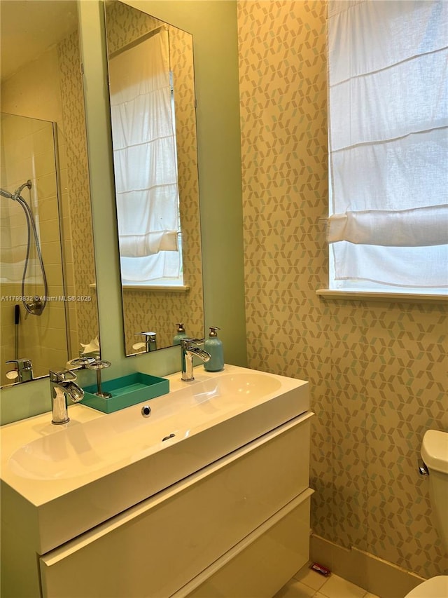 1614 Pennsylvania Ave Unit 2I, Miami Beach, FL 33139 - full bathroom featuring toilet, vanity, tile patterned flooring, and a shower