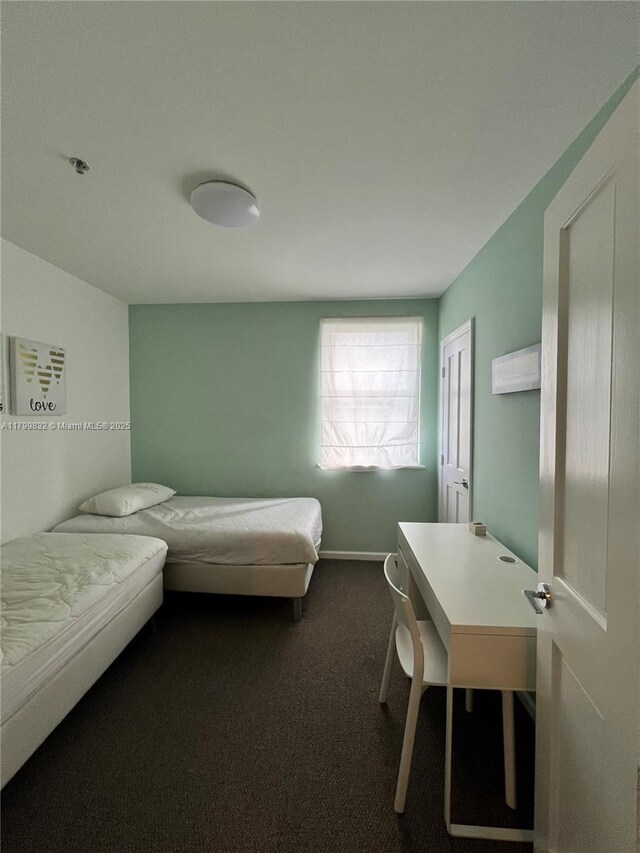 1614 Pennsylvania Ave Unit 2I, Miami Beach, FL 33139 - bedroom with dark carpet and baseboards