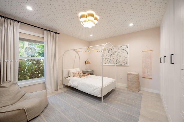 bedroom with recessed lighting, baseboards, and a chandelier