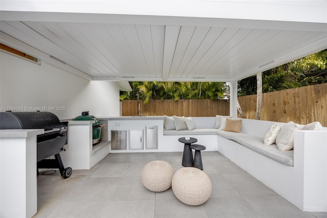 view of patio / terrace with area for grilling and a fenced backyard