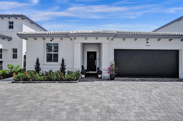 14836 SW 162nd St, Miami, FL 33187 - view of front facade with a garage, decorative driveway, and stucco siding