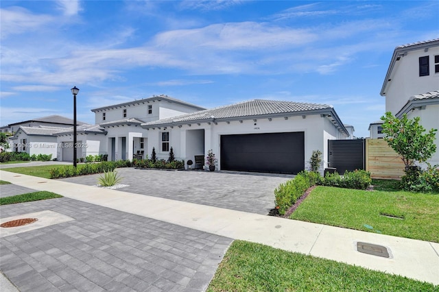 14836 SW 162nd St, Miami, FL 33187 - mediterranean / spanish-style house featuring an attached garage, decorative driveway, a tiled roof, and stucco siding