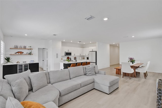 14836 SW 162nd St, Miami, FL 33187 - living room featuring recessed lighting, light wood-type flooring, and wine cooler