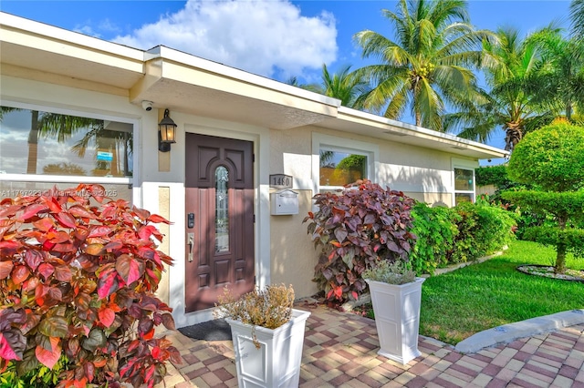 1480 SW 5th Ave, Deerfield Beach, FL 33441 - doorway to property with stucco siding and a security system