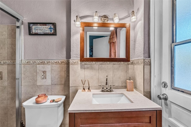 1480 SW 5th Ave, Deerfield Beach, FL 33441 - full bathroom featuring healthy amount of natural light, vanity, toilet, a textured wall, and a shower with shower door