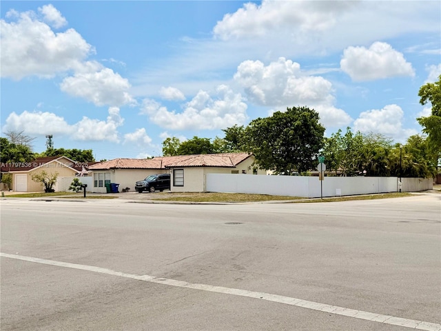 5730 NW 199th St, Hialeah, FL 33015 - view of asphalt road with sidewalks, traffic signs, and curbs