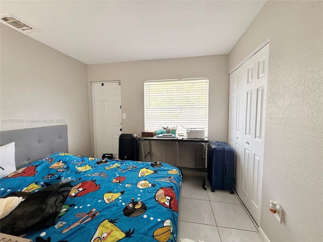 5730 NW 199th St, Hialeah, FL 33015 - bedroom featuring light tile patterned flooring, a closet, and a textured wall